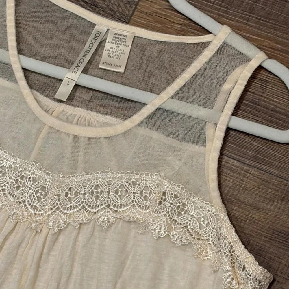 Cream lace tank top with sheer mesh and lace trim on the shoulders